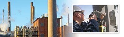 Brick factory with large stacks/flues; FCI engineer installing meter in large stack